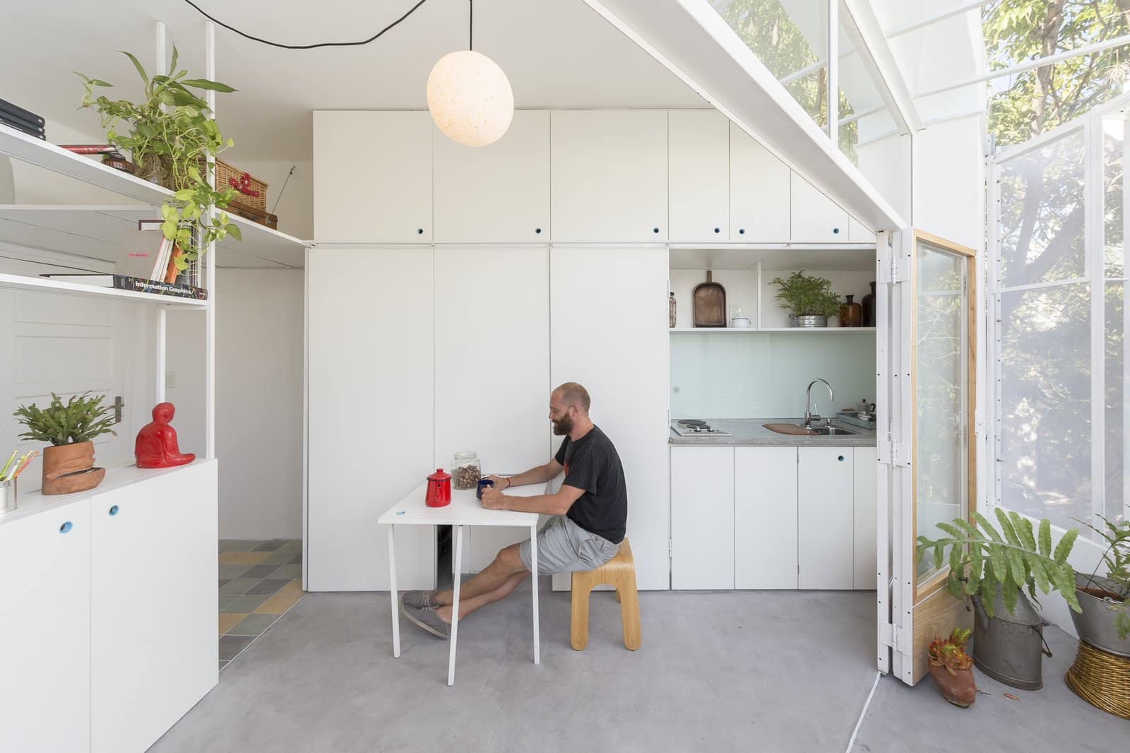 A pull out dining table is concealed behind one of the white kitchen panels1