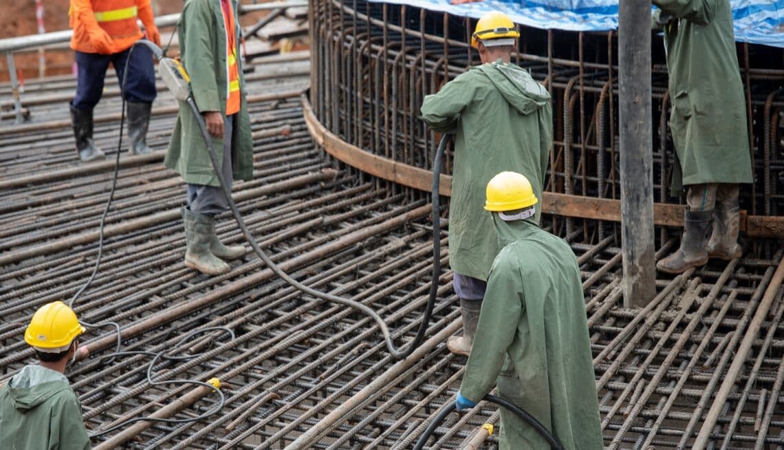 Construction worker pouring a concrete at mass foundation