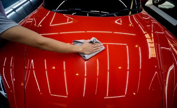 Car service worker applying nano coating on a car detail. Tools for polishing