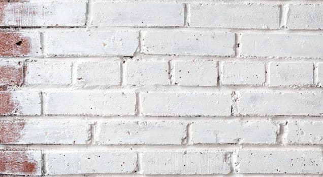 Brick wall painted with white paint