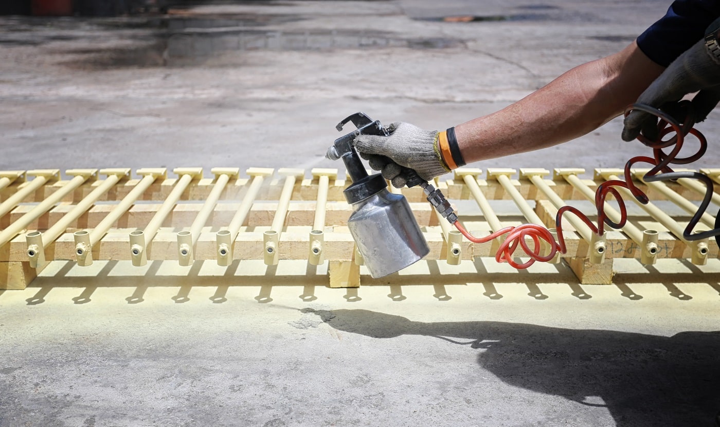 Workers spraying automotive parts in concept of work manufacturing industry.