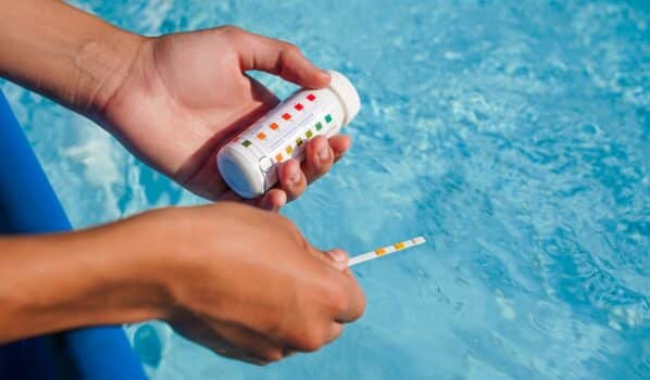 Swimming pool ph checking. Green water, green pool problem as background. High quality photo