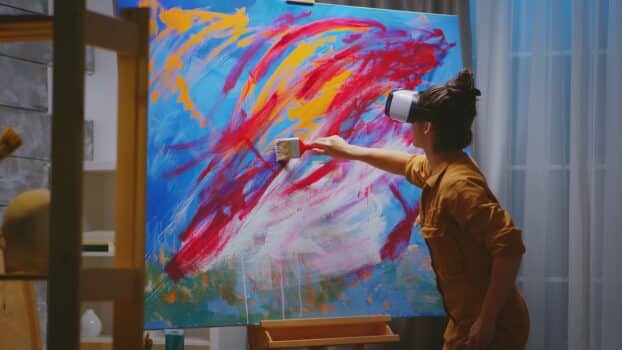 Creative artist painting using vr headset in studio. Vr painting