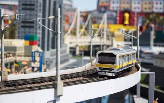 Nagoya, japan - april 08, 2019: local jr train lego model running on railway with city background of japan legoland. Famous theme park landmark espcially for children age around 1 to 7 years old.