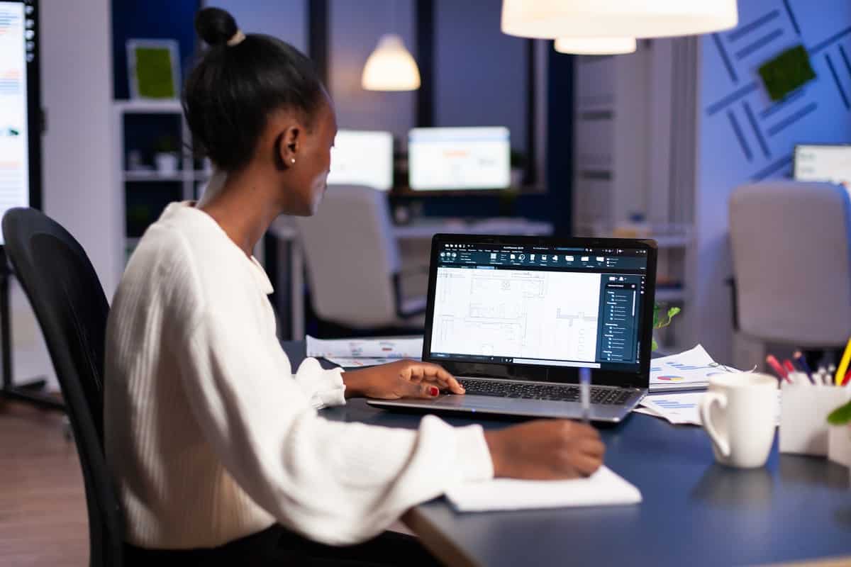 African engineer constructor designer architect analysing new bluilding plan in cad program working in business office. Industrial woman employee studying prototype idea showing cad software on device display.