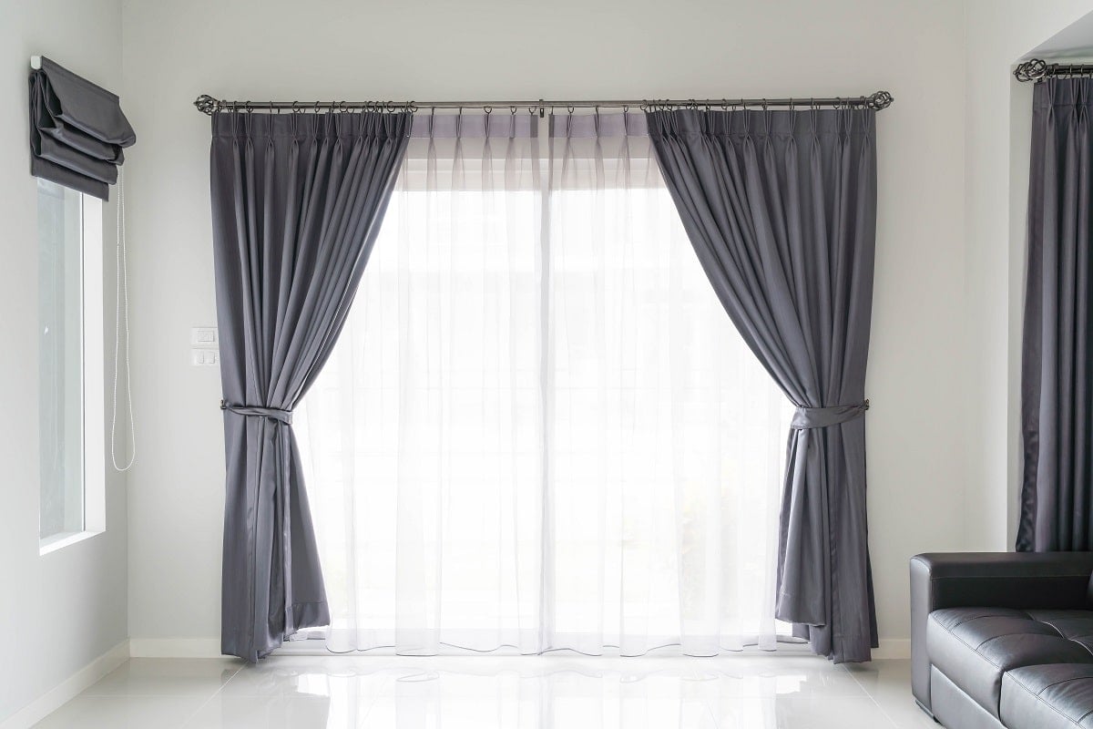 Curtain interior decoration in living room with sunlight. Do blackout curtains keep heat out.