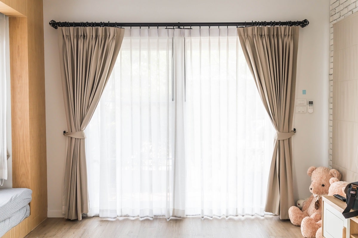 Curtain interior decoration in living room with sunlight. How to combine sheer and blackout curtains.