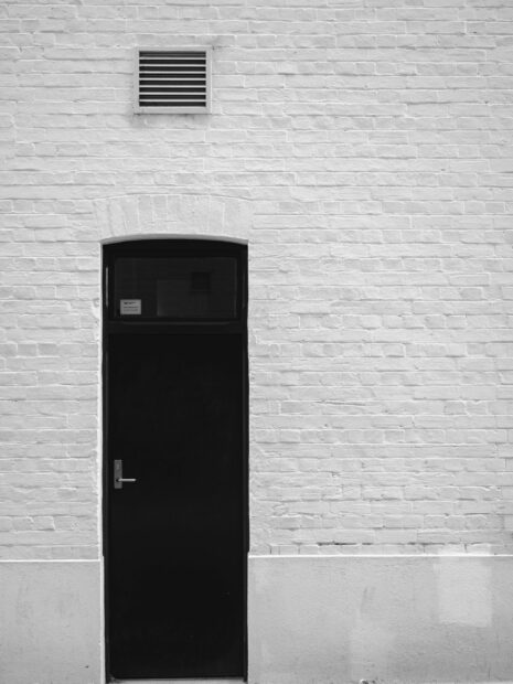 Black soundproof door on a concrete wall